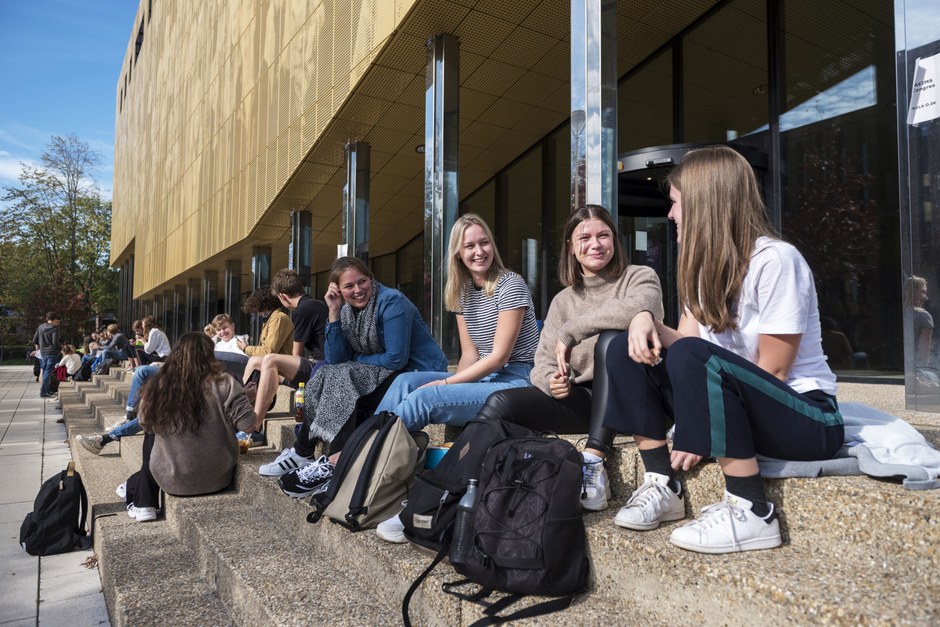 People sitting on broad city steps